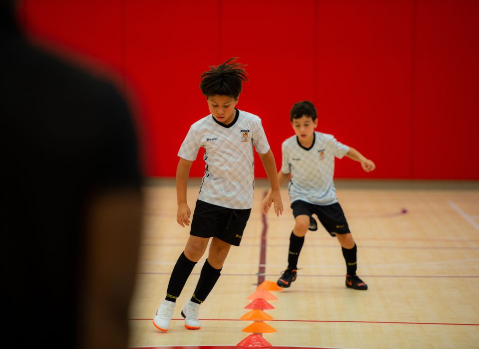 upper primary students playing soccer during after school activities